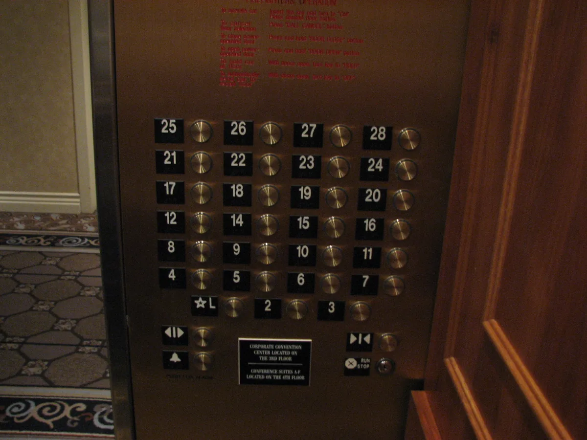 Hotel elevator button panel with floors 1 to 28 where the row runs 12, 14, 15, 16, so no 13 button