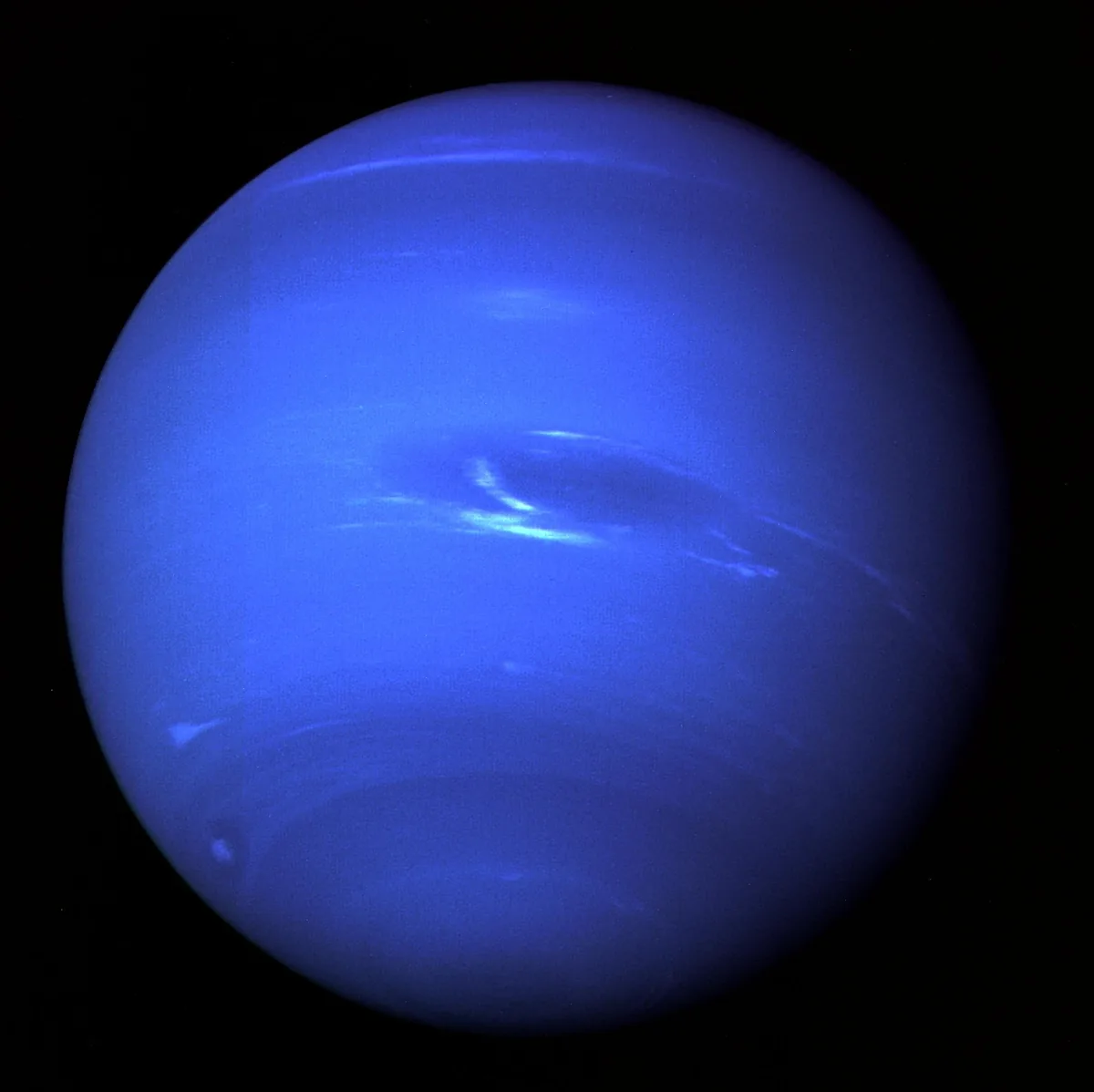 Voyager 2 image of the blue planet Neptune showing the Great Dark Spot and white clouds