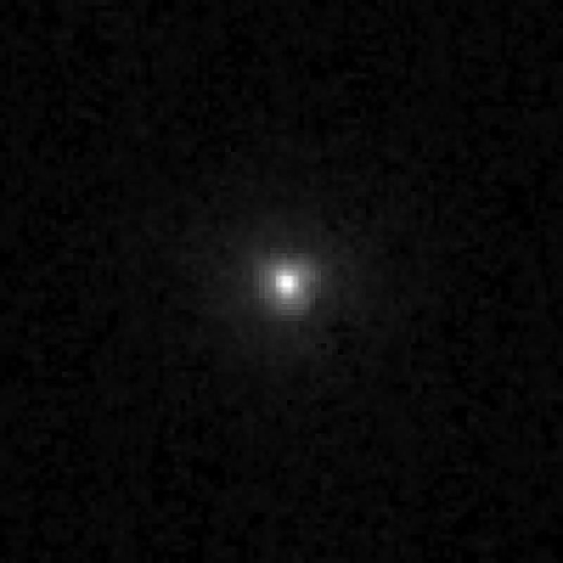 Hubble Space Telescope image of the centaur 2060 Chiron as a small fuzzy point of light on a black background