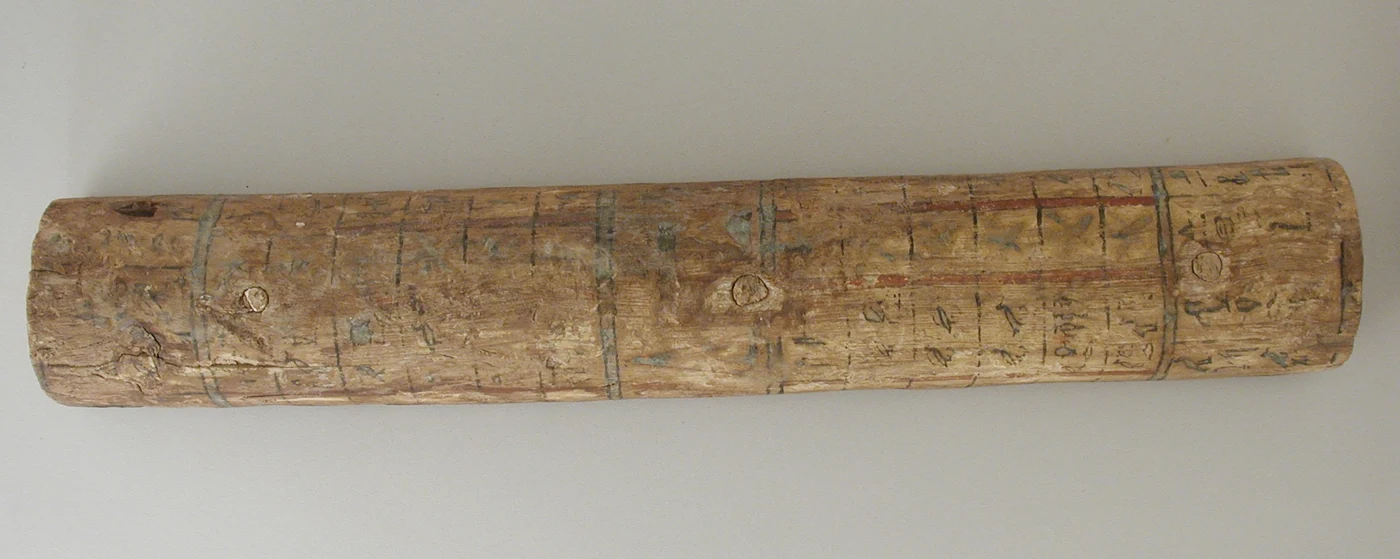 Painted wooden strip from a Middle Kingdom Egyptian coffin lid with a grid of hieroglyphs naming decan stars