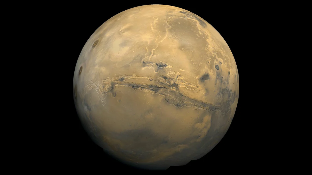 Photograph of the red planet Mars with the Valles Marineris canyon system across its face, from NASA Viking images